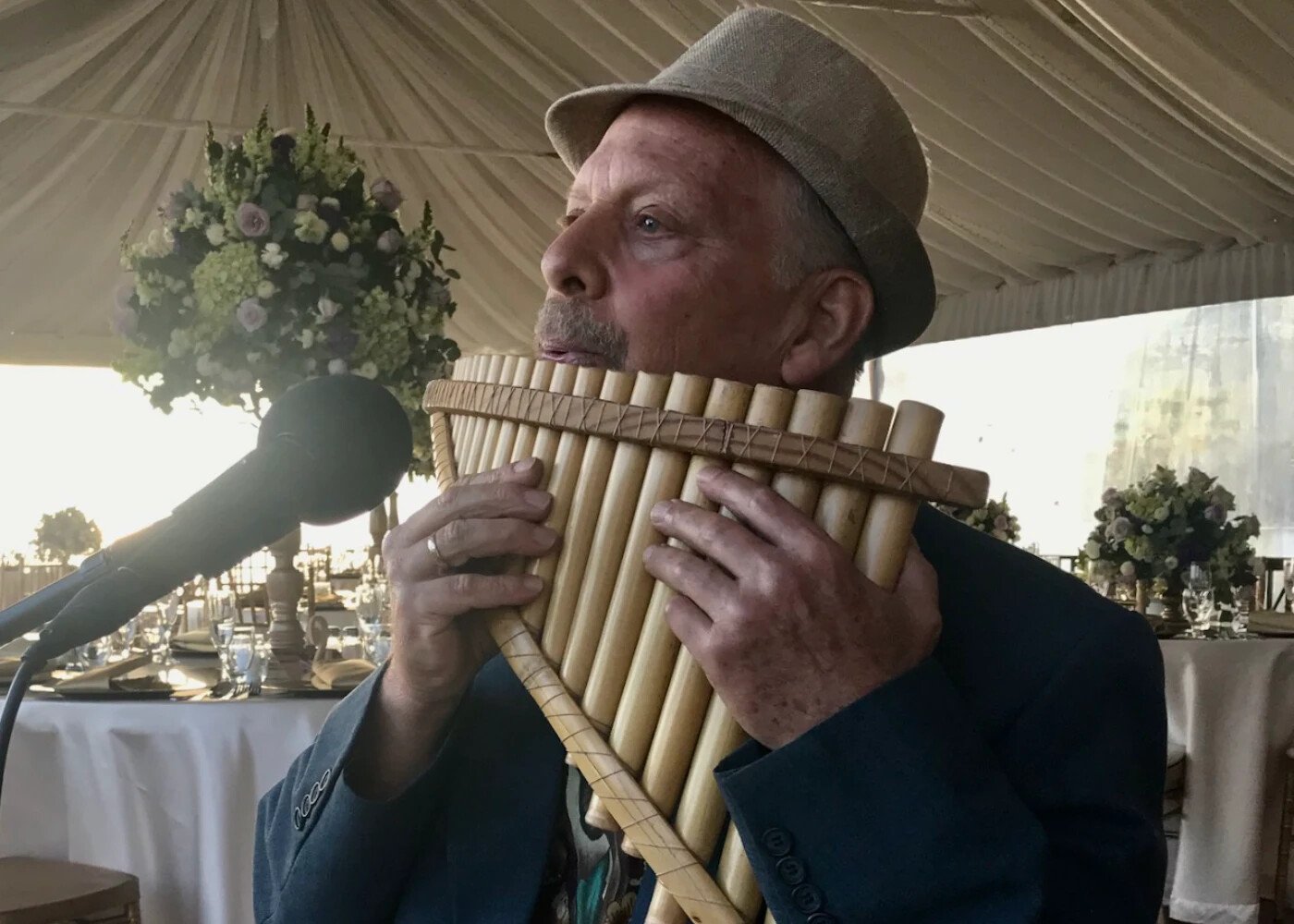 Mark playing the pan flute at a wedding reception